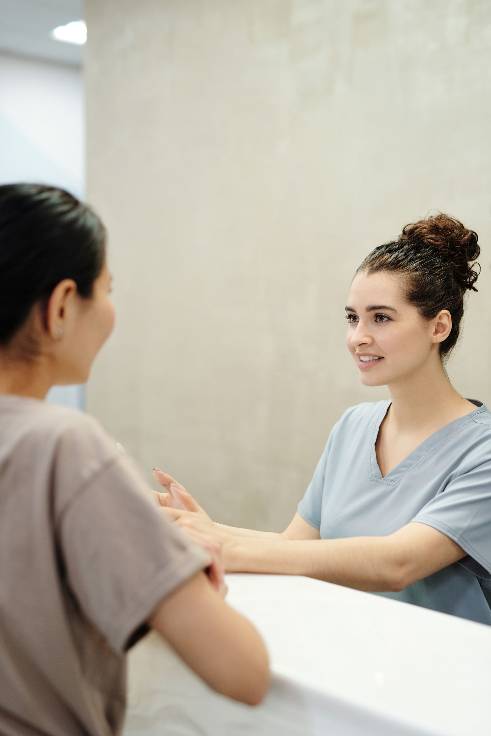 A nurse listening attentively during a friendly conversation at a clinic